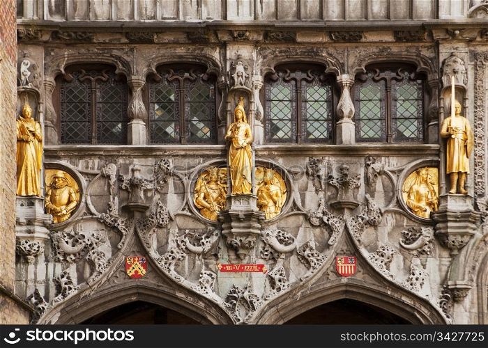 Gilded stone statues decorate the entrance over the doors to the Basilius, or Basilica of the Holy Blood, in Bruges, Belgium.