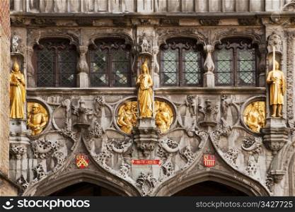 Gilded stone statues decorate the entrance over the doors to the Basilius, or Basilica of the Holy Blood, in Bruges, Belgium.