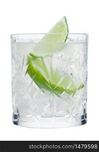 Gimlet cocktail in crystal glass with ice cubes and lime slices isolated on white background.