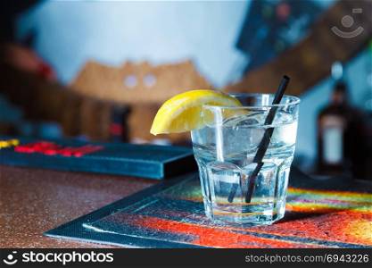 gin at the bar with a slice of lemon. close-up