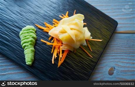 Ginger and Wasabi on a carrots bed and black slate board