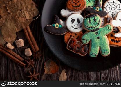 Ginger biscuits for Halloween holiday on wooden table with copy space. Ginger biscuits for Halloween