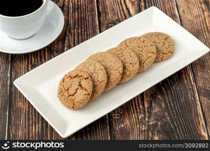 Ginger cinnamon cookies with filter coffee on wooden background