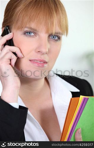 Ginger haired woman holding documents
