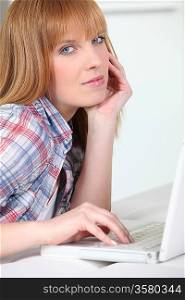 Ginger haired woman with laptop