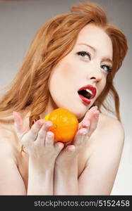 Ginger lady with a mandarine