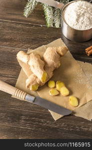 Ginger root and sliced on old kitchen countertop.