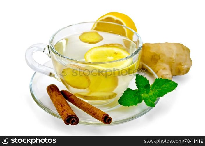 Ginger tea in a glass cup, lemon, cinnamon, ginger, mint isolated on white background