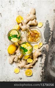 Ginger tea with honey and lemon. On rustic background.. Ginger tea with honey and lemon.