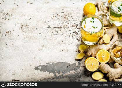 Ginger tea with honey and lemon. On rustic background.. Ginger tea with honey and lemon.