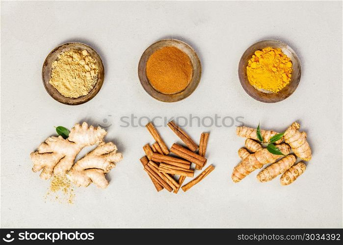 Ginger, turmeric and cinnamon - Spices for healthy drinks - turmeric tea or golden turmeric latte. Top view, copy space. Ginger, turmeric and cinnamon