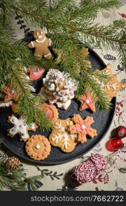 Gingerbread Christmas Cookie on Plate and Pine Brunches