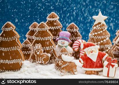 Gingerbread christmas fir trees Santa Claus and gift cookies winter holiday celebration concept. Gingerbread Santa in forest