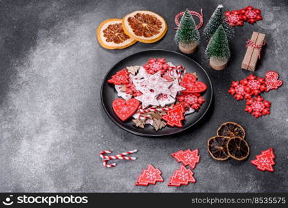 Gingerbread, Christmas tree decorations, dried citrus fruits on a gray concrete background to prepare a festive Christmas table. Gingerbread, Christmas tree decorations, dried citrus fruits on a gray concrete background