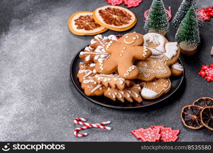 Gingerbread, Christmas tree decorations, dried citrus fruits on a gray concrete background to prepare a festive Christmas table. Gingerbread, Christmas tree decorations, dried citrus fruits on a gray concrete background