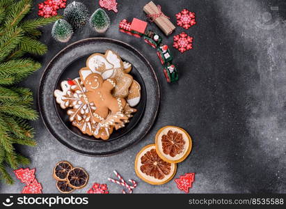 Gingerbread, Christmas tree decorations, dried citrus fruits on a gray concrete background to prepare a festive Christmas table. Gingerbread, Christmas tree decorations, dried citrus fruits on a gray concrete background