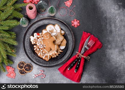 Gingerbread, Christmas tree decorations, dried citrus fruits on a gray concrete background to prepare a festive Christmas table. Gingerbread, Christmas tree decorations, dried citrus fruits on a gray concrete background