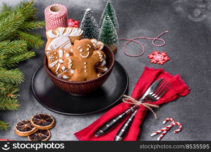 Gingerbread, Christmas tree decorations, dried citrus fruits on a gray concrete background to prepare a festive Christmas table. Gingerbread, Christmas tree decorations, dried citrus fruits on a gray concrete background