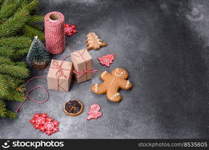 Gingerbread, Christmas tree decorations, dried citrus fruits on a gray concrete background to prepare a festive Christmas table. Gingerbread, Christmas tree decorations, dried citrus fruits on a gray concrete background