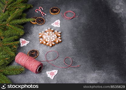 Gingerbread, Christmas tree decorations, dried citrus fruits on a gray concrete background to prepare a festive Christmas table. Gingerbread, Christmas tree decorations, dried citrus fruits on a gray concrete background