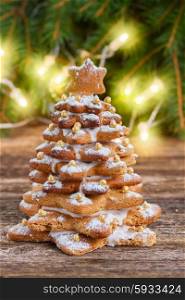 gingerbread christmas tree. one baked gingerbread tree with christmas lights in background