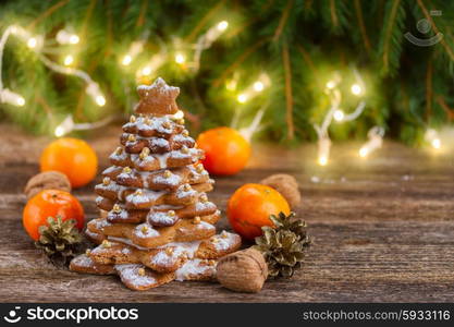 gingerbread christmas tree. one gingerbread tree with tabgerines and christmas lights in background