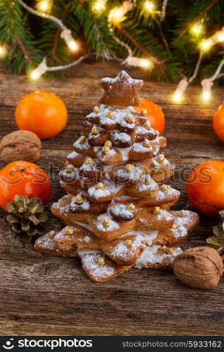 gingerbread christmas tree. one gingerbread tree with tangerines and christmas lights in background