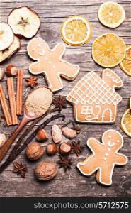 Gingerbread cookies on a wooden table with ingredients
