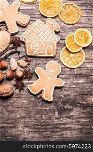 Gingerbread cookies on a wooden table with ingredients. Gingerbread cookies