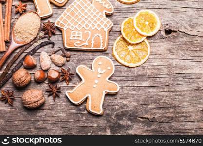 Gingerbread cookies on a wooden table with ingredients. Gingerbread cookies