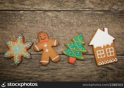 Gingerbread cookies over wooden background