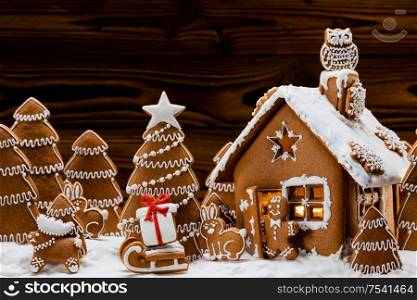 Gingerbread house christmas fir trees and gift cookies winter holiday celebration concept. Gingerbread house and trees