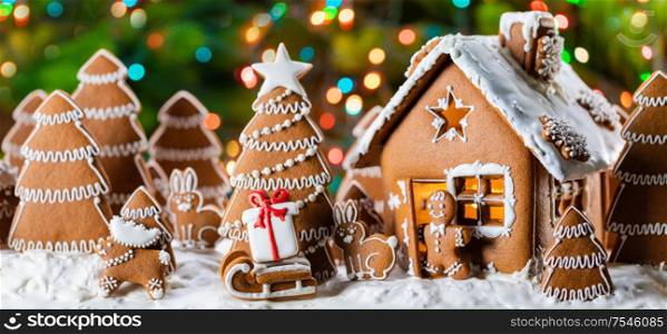 Gingerbread house christmas fir trees gift and animals cookies winter holiday celebration concept. Gingerbread house and trees