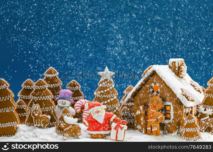 Gingerbread house christmas fir trees Santa Claus and gift cookies winter holiday celebration concept. Gingerbread house and trees