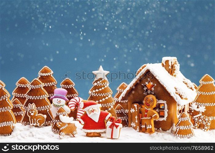 Gingerbread house christmas fir trees Santa Claus and gift cookies winter holiday celebration concept. Gingerbread house and trees