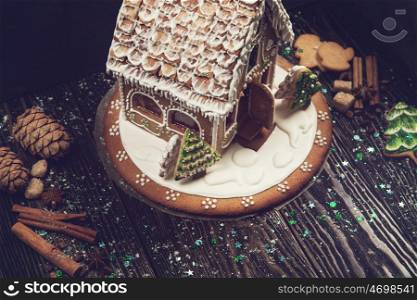 gingerbread house for new years and christmas on wooden background, xmas theme