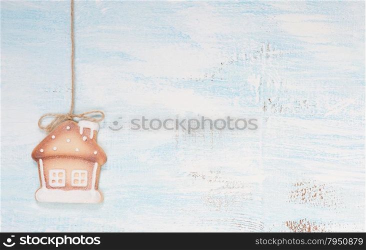 Gingerbread house-shaped on the wooden background