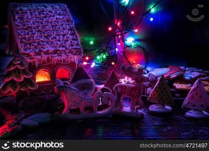 Gingerbread house with lights on dark background, xmas theme