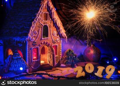 Gingerbread house with lights on dark background, xmas theme. Gingerbread house with lights