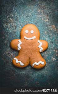 Gingerbread man cookie on rustic background, top view