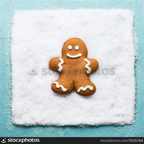Gingerbread man on snow. Christmas cookie. Modern creative winter holiday concept