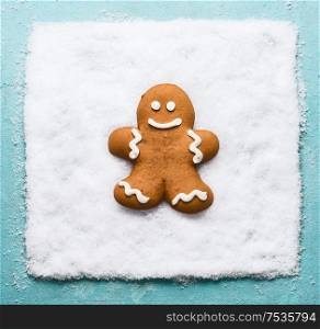 Gingerbread man on snow. Christmas cookie. Modern creative winter holiday concept
