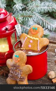 Gingerbread men with mug of hot chocolate. two Gingerbread men with mug of chocolate and glowing lantern on wood