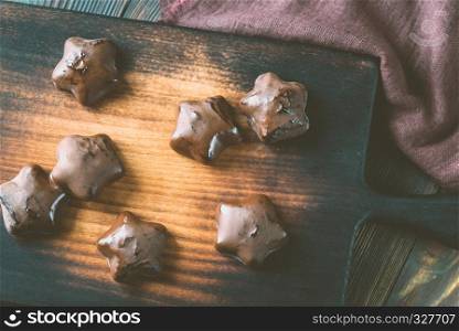 Gingerbread stars on the wooden board
