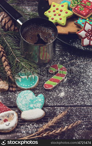 Gingerbreads and coffee for new years and christmas on wooden background, xmas theme