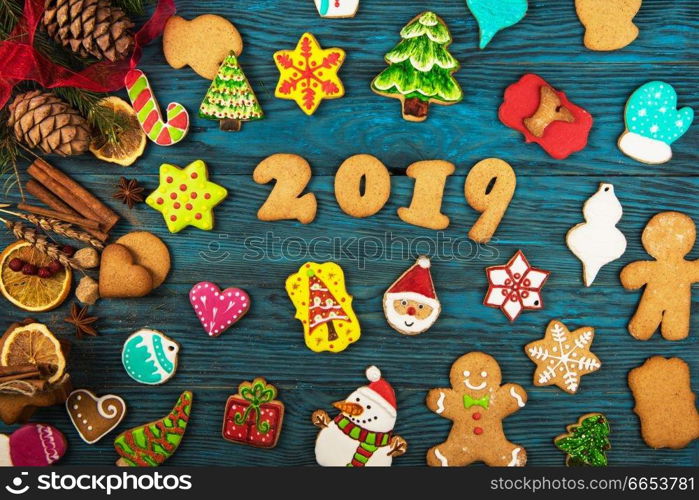 Gingerbreads cookies for new 2019 year holiday on wooden background, xmas theme. Gingerbreads for new 2019 years