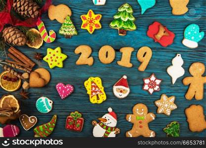 Gingerbreads cookies for new 2019 year holiday on wooden background, xmas theme. Gingerbreads for new 2019 years