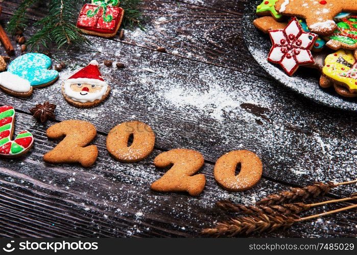 Gingerbreads cookies for New 2020 Year and christmas on wooden background, xmas theme. Gingerbreads for New 2020 Year