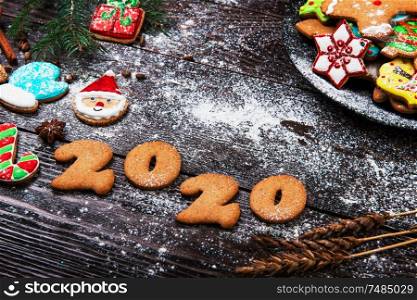 Gingerbreads cookies for New 2020 Year and christmas on wooden background, xmas theme. Gingerbreads for New 2020 Year