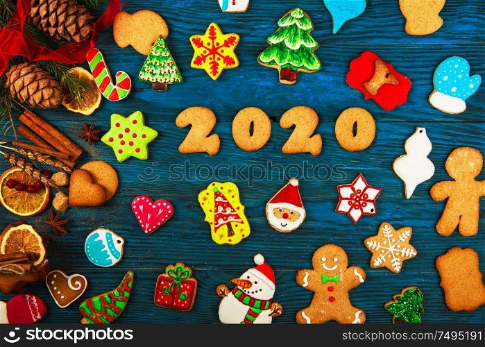 Gingerbreads cookies for new 2020 year holiday on wooden background, xmas theme. Gingerbreads for new 2020 years